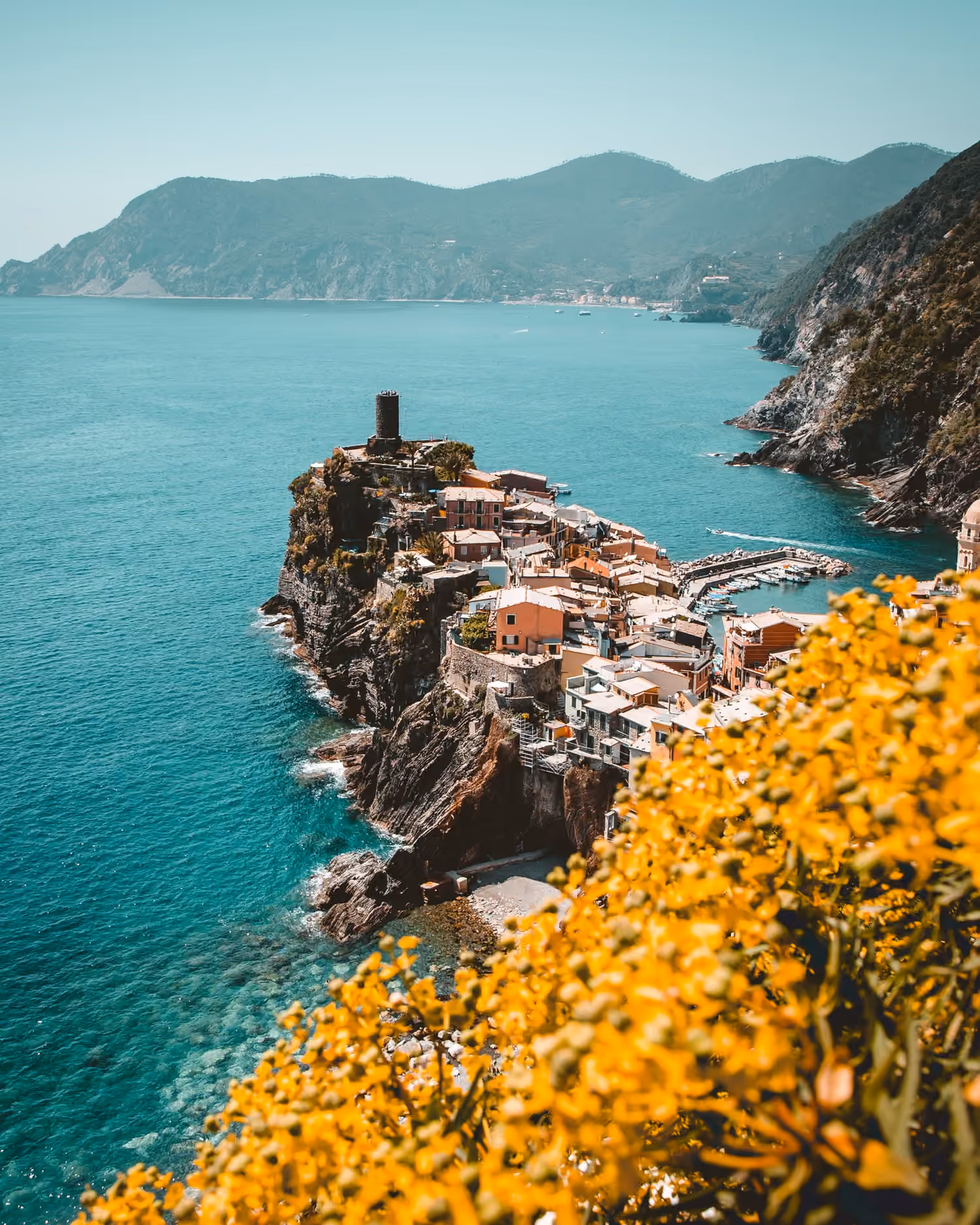 Colourful cliffside village on the Italian coast, with the sea below