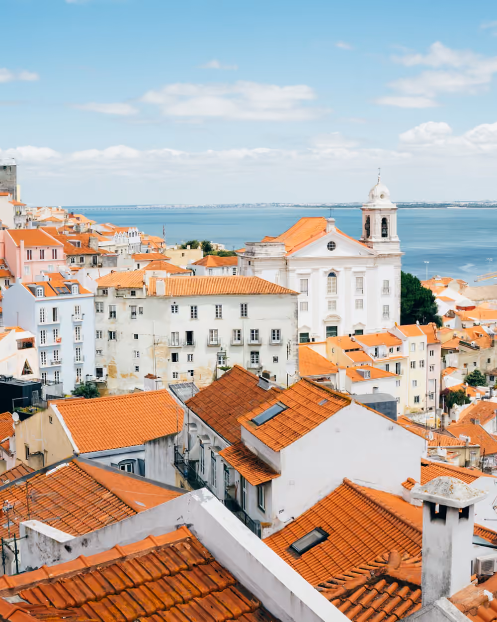 Terracotta rooftops of a hillside town above the sea