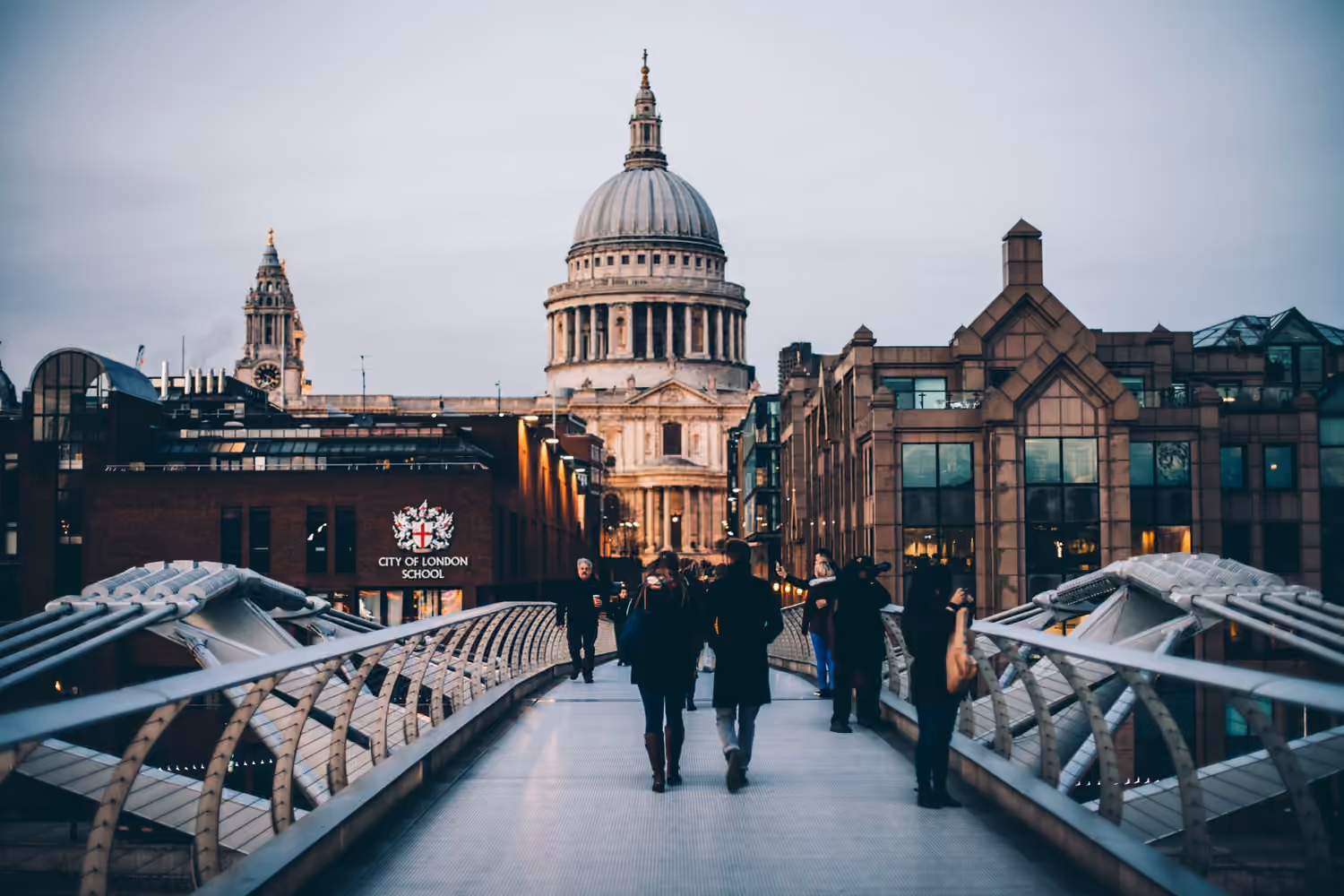People walking across the Millennium Bridge towards St Paul's Cathedral