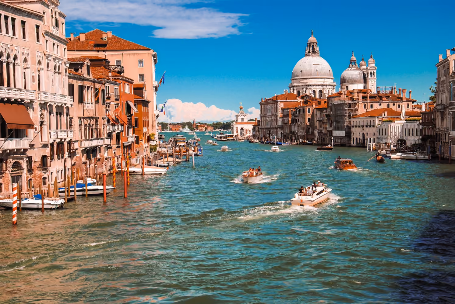 Boats on the Grand Canal in front of a domed church